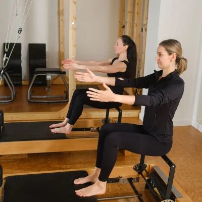 2-women-balance-on-a-pilates-reformer-machine-in-2024-05-08-17-41-08-utc-2880w