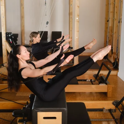 3-two-women-balance-on-a-pilates-reformer-machine-in-2024-05-08-17-41-08-utc-3099451c-1920w